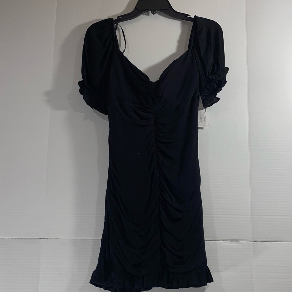 B darling black dress 100% rayon outer and 100% poly lining.